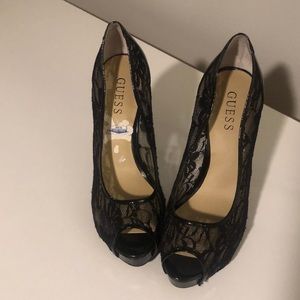 Gently worn black guess lace and patent leather peep toe heels.